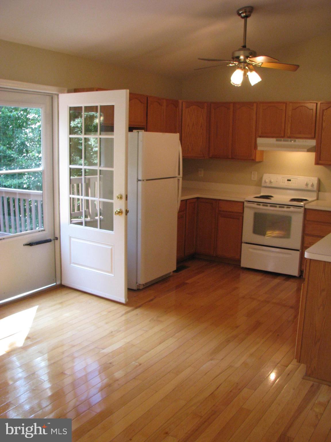 28434 Walnut Ridge Way Rhoadesville, VA 22542 - Photo 6 of 37 Hardwood floors in kitchen and door to deck