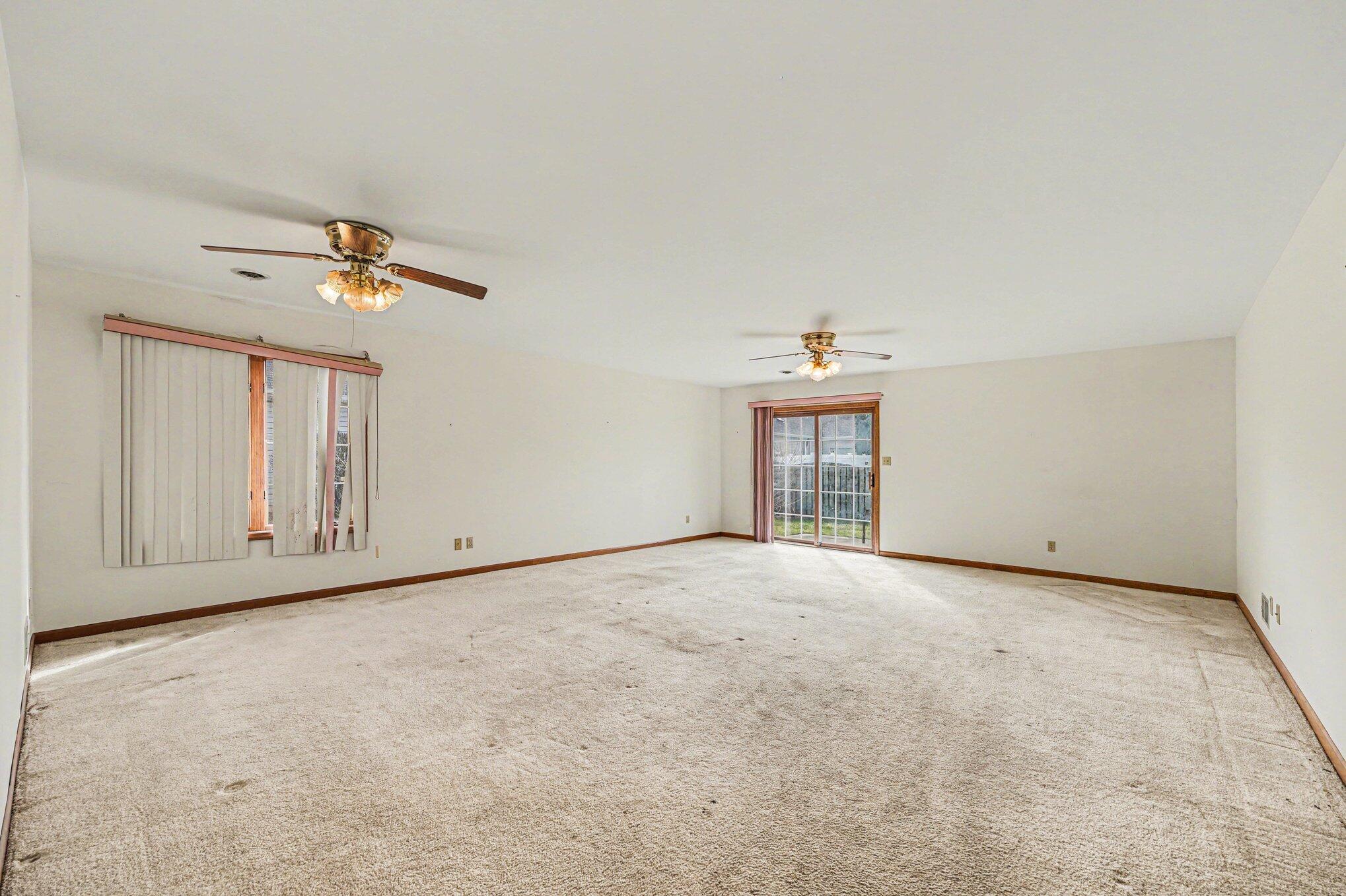 950 Blue Jay Way Dyer, IN 46311 - Photo 16 of 21 an empty room with a ceiling fan and a window