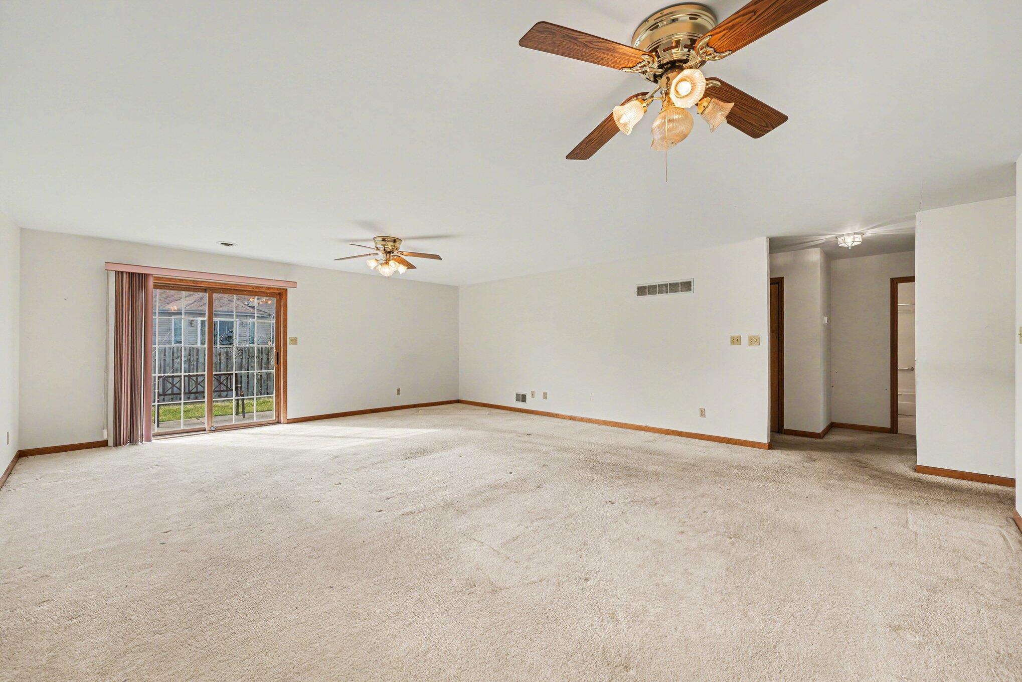 950 Blue Jay Way Dyer, IN 46311 - Photo 18 of 21 an empty room with chandelier fan and windows