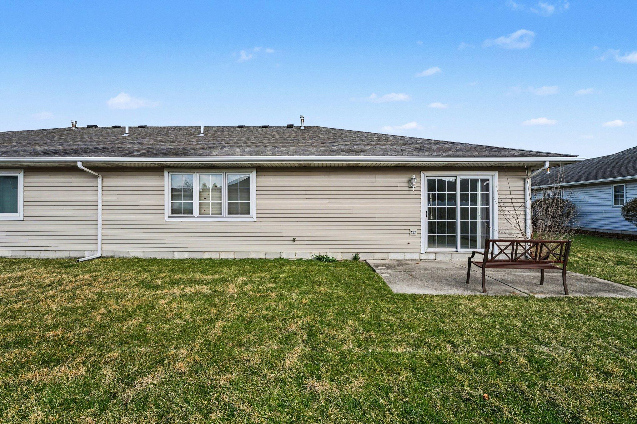 950 Blue Jay Way Dyer, IN 46311 - Photo 2 of 21 a backyard of a house with table and chairs