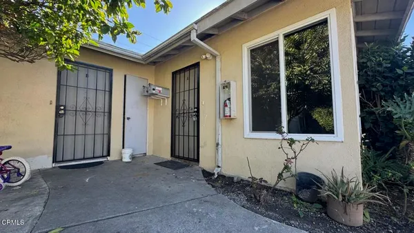 a view of house with backyard space and porch