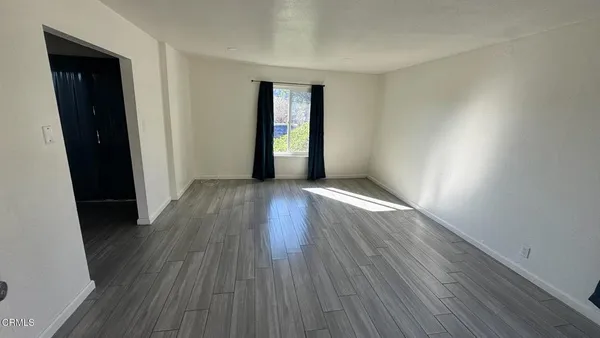 wooden floor in an empty room and a window