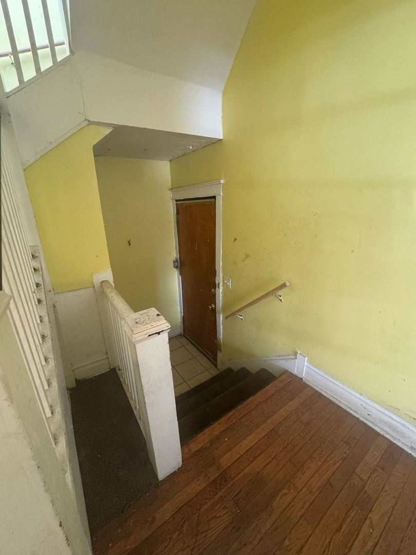 7007 South Ada Street Chicago, IL 60636 - Photo 14 of 49 a view of an empty room with wooden floor