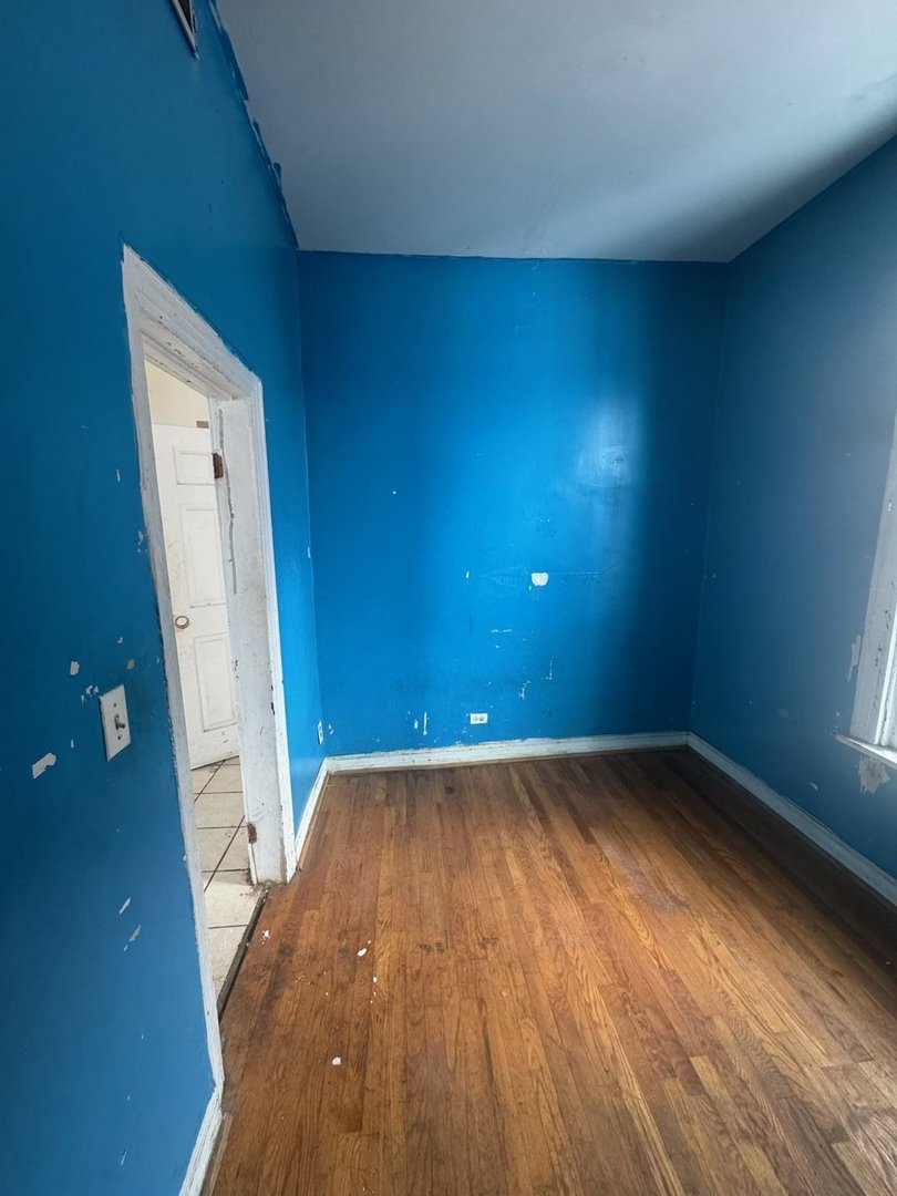 7007 South Ada Street Chicago, IL 60636 - Photo 29 of 49 wooden floor in an empty room with a window