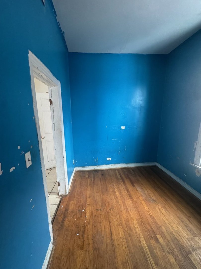 7007 South Ada Street Chicago, IL 60636 - Photo 30 of 49 an empty room with wooden floor and a sink