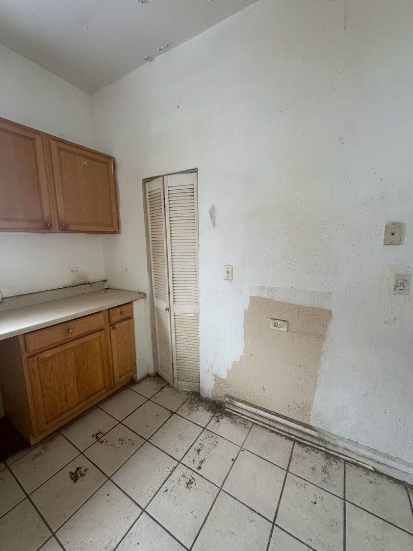 7007 South Ada Street Chicago, IL 60636 - Photo 32 of 49 a kitchen with a sink and cabinets