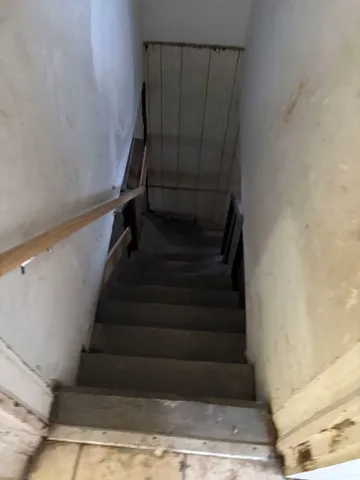 a view of an empty room with stairs and ventilation