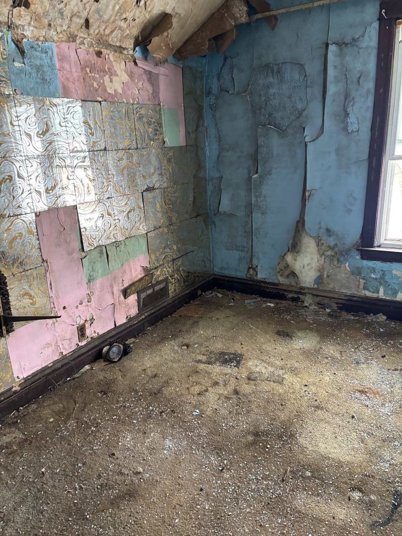 7007 South Ada Street Chicago, IL 60636 - Photo 7 of 22 a room with water heater and a wooden floor