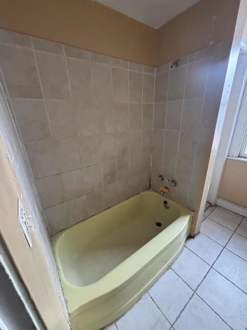 7007 South Ada Street Chicago, IL 60636 - Photo 8 of 49 a bathroom with a tub a sink and a shower