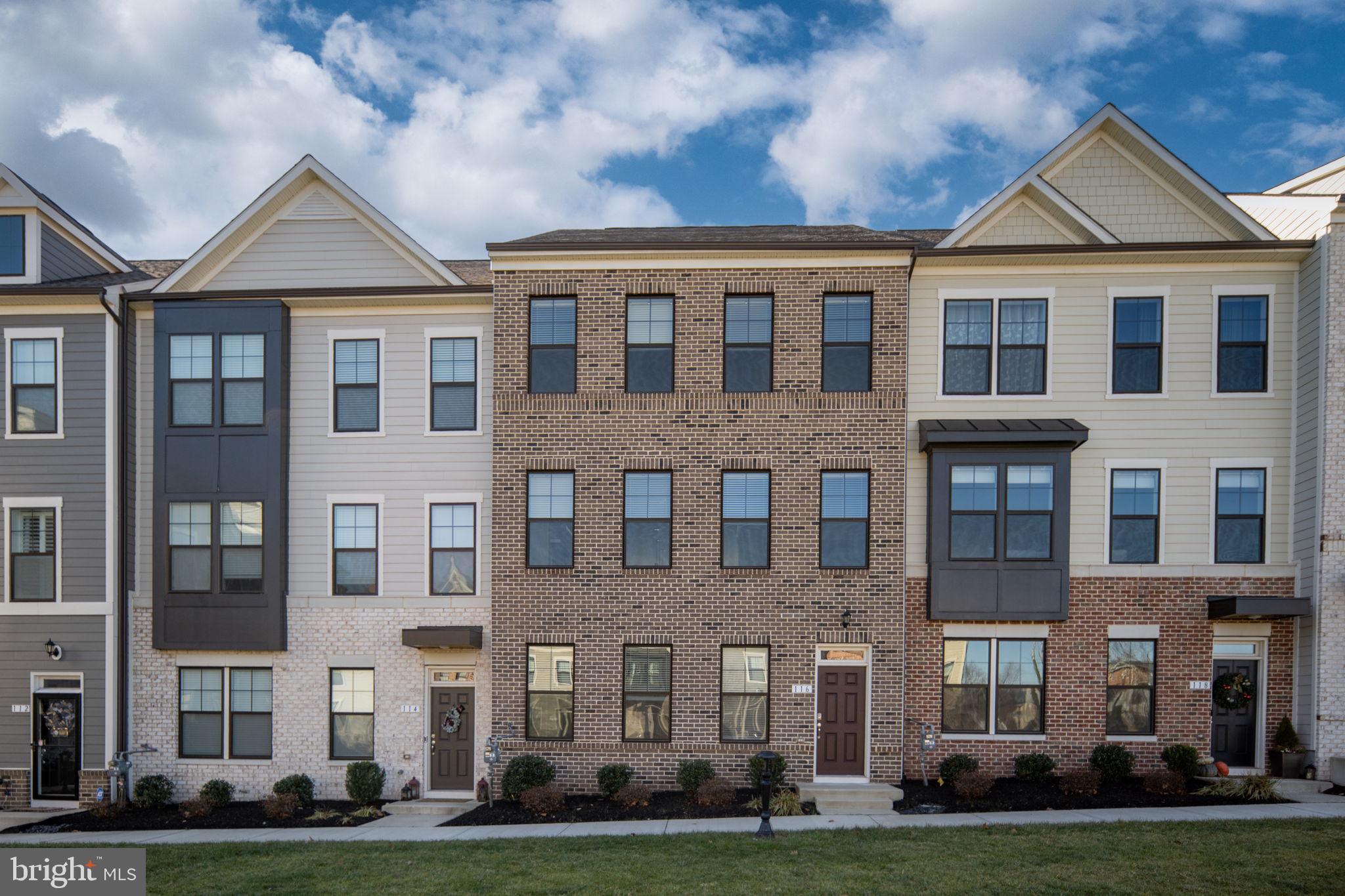 a view of a brick building next to a yard
