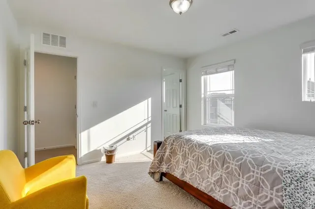 a bedroom with a bed and a couch