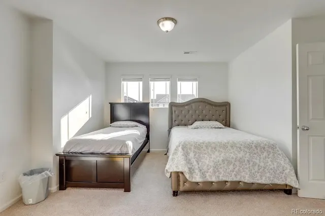 a bedroom with a bed and a couch