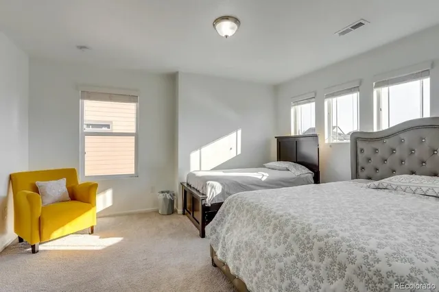 a bedroom with two beds and a couch