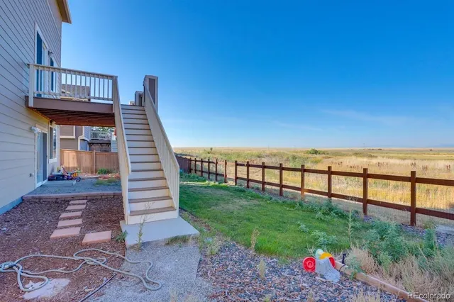 a view of a backyard with sitting area