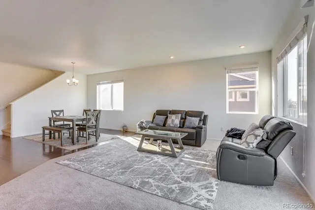 a living room with furniture window and wooden floor