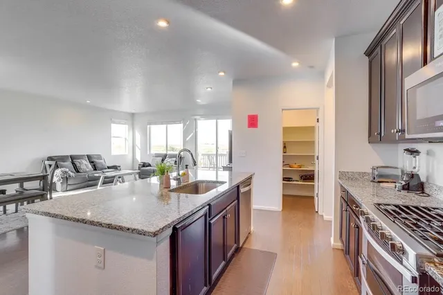 a kitchen with granite countertop a sink and cabinets