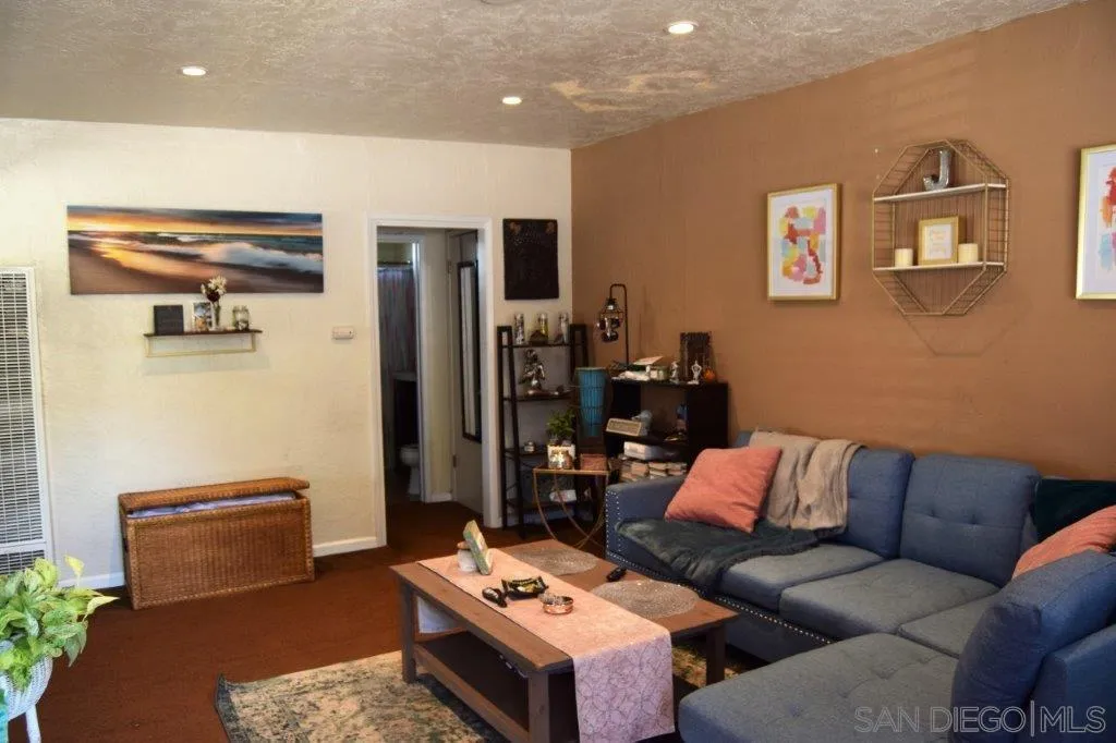 3159-3161 Cedar Street San Diego, CA 92102 - Photo 22 of 39 a living room with furniture a flat screen tv and a refrigerator