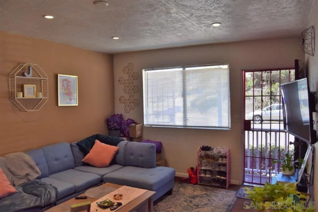 3159-3161 Cedar Street San Diego, CA 92102 - Photo 23 of 39 a living room with furniture and a window