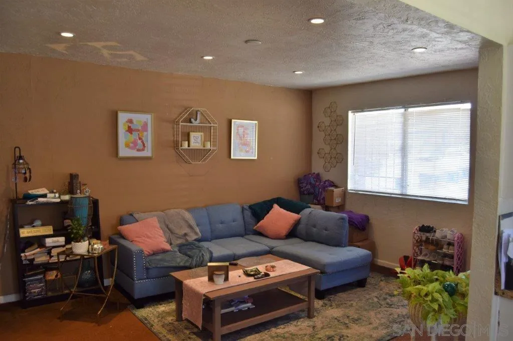 3159-3161 Cedar Street San Diego, CA 92102 - Photo 24 of 39 a living room with furniture and a window