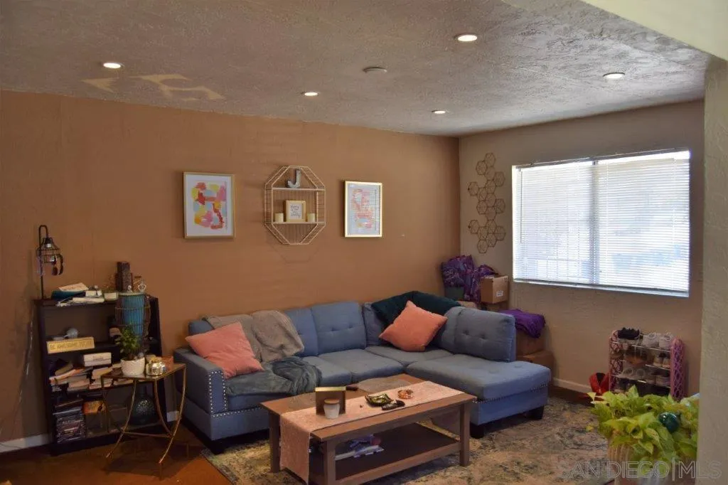 3159-3161 Cedar Street San Diego, CA 92102 - Photo 25 of 39 a living room with furniture a window and a bookshelf
