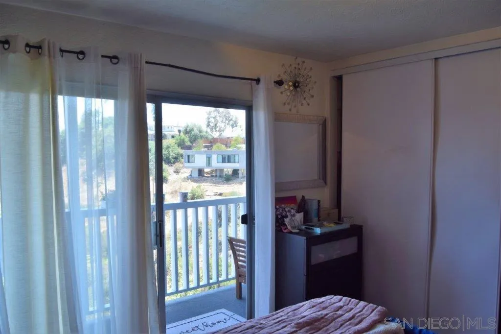 3159-3161 Cedar Street San Diego, CA 92102 - Photo 33 of 39 a bedroom with a balcony a bed and a window