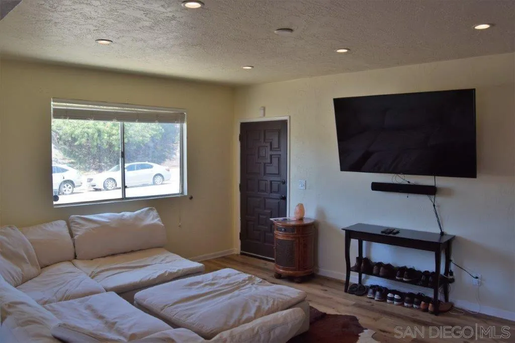 3159-3161 Cedar Street San Diego, CA 92102 - Photo 4 of 39 a bedroom with furniture and a flat screen tv
