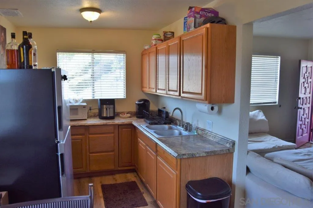 3159-3161 Cedar Street San Diego, CA 92102 - Photo 7 of 39 a kitchen that has a sink and a stove in it