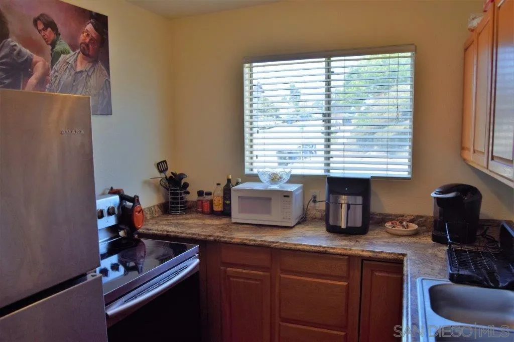 3159-3161 Cedar Street San Diego, CA 92102 - Photo 8 of 39 a kitchen with sink refrigerator and window
