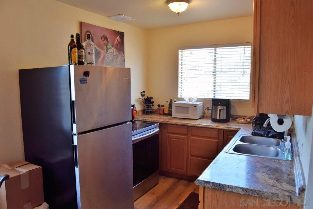 3159-3161 Cedar Street San Diego, CA 92102 - Photo 9 of 39 a room with wooden floor and window