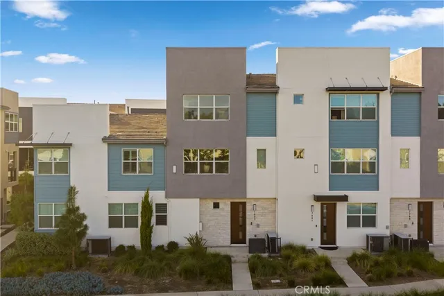a front view of a residential apartment building with a yard