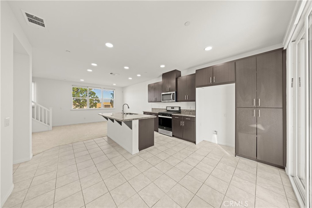7803 Paxton Place Rancho Cucamonga, CA 91730 - Photo 16 of 44 a kitchen with stainless steel appliances a refrigerator sink and microwave