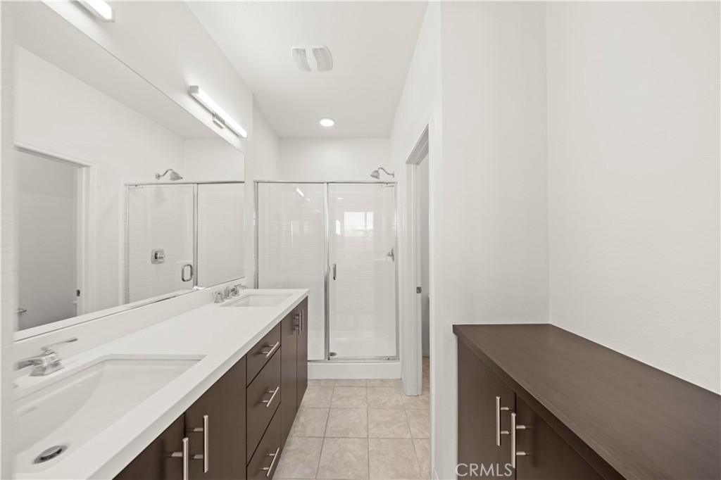 7803 Paxton Place Rancho Cucamonga, CA 91730 - Photo 28 of 44 a spacious bathroom with a double vanity sink a mirror and a bathtub