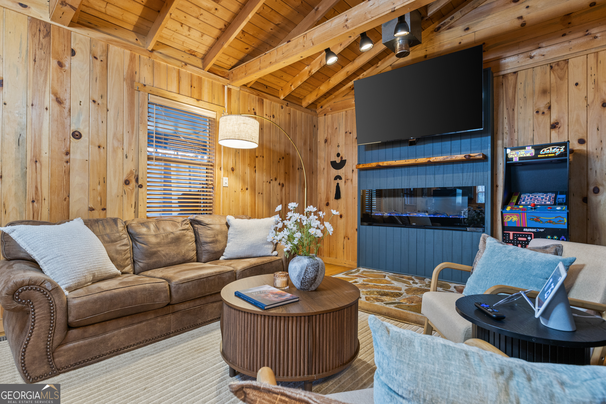 222 Icy Lane Blue Ridge, GA 30513 - Photo 13 of 37 a living room with furniture a flat screen tv and a fireplace