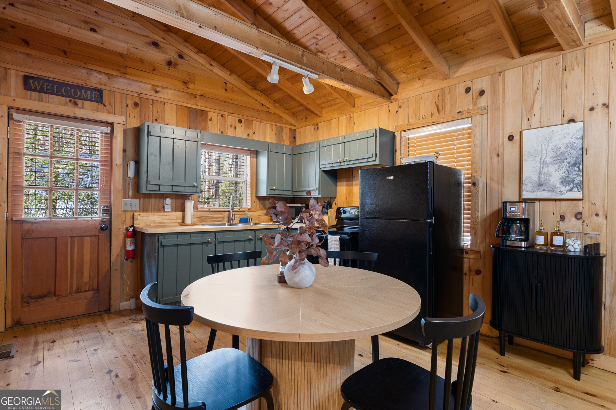 222 Icy Lane Blue Ridge, GA 30513 - Photo 8 of 37 a kitchen with stainless steel appliances a table chairs and refrigerator
