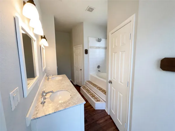 a en suite bathroom with a sink a mirror and a shower