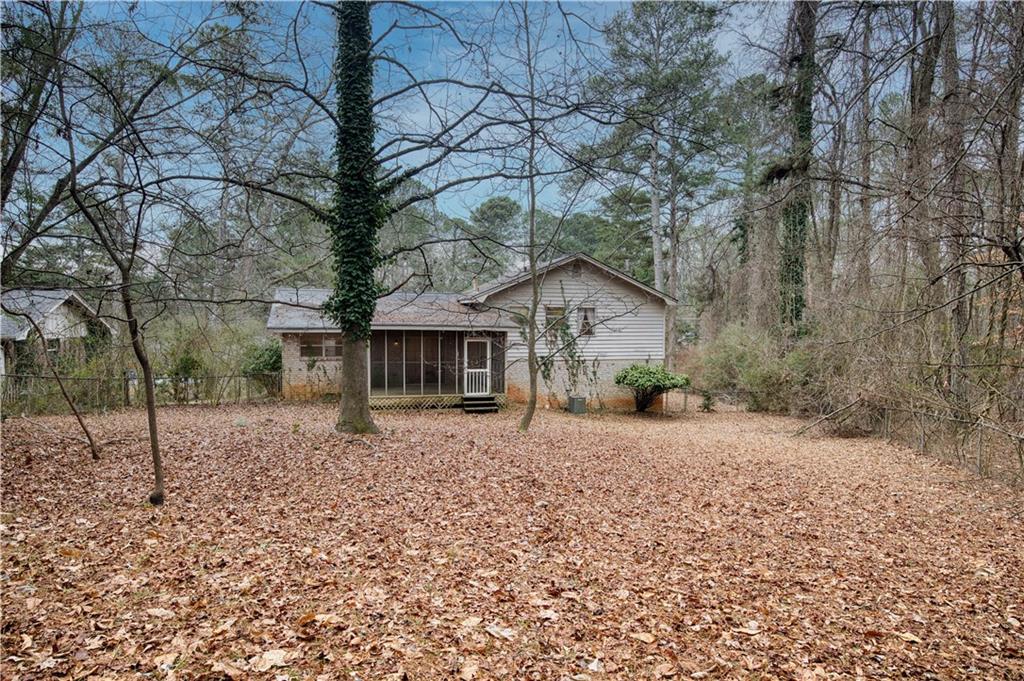 6100 Mincey Road Stone Mountain, GA 30087 - Photo 16 of 40 a front view of a house with a yard and garage