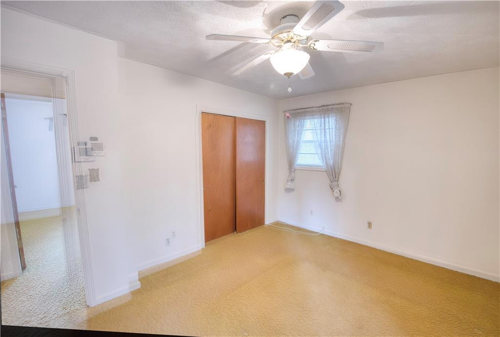 6100 Mincey Road Stone Mountain, GA 30087 - Photo 21 of 40 a view of a big room with closet fan and windows