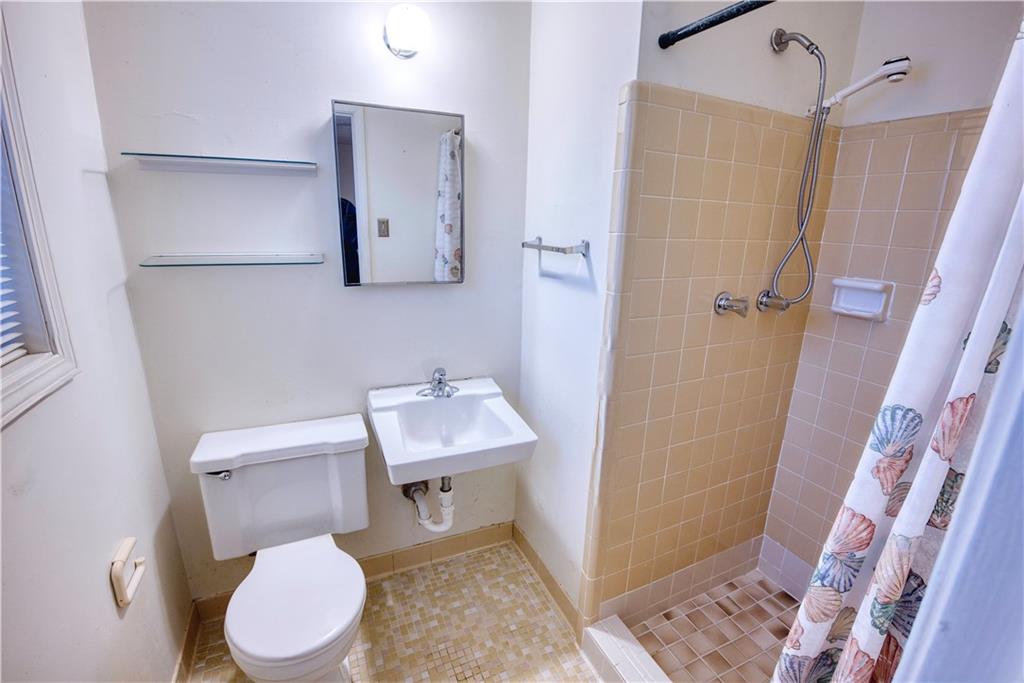 6100 Mincey Road Stone Mountain, GA 30087 - Photo 23 of 40 a bathroom with a toilet sink and shower