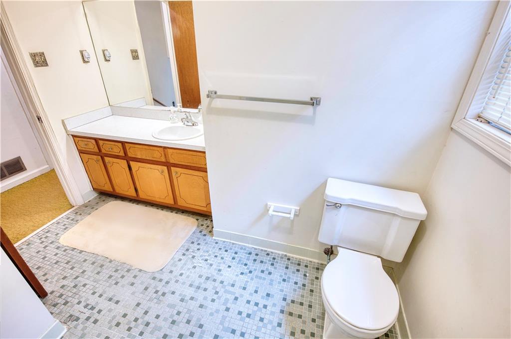 6100 Mincey Road Stone Mountain, GA 30087 - Photo 24 of 40 a bathroom with a toilet and a sink