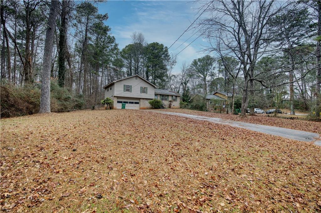 6100 Mincey Road Stone Mountain, GA 30087 - Photo 27 of 40 a view of a backyard with large trees