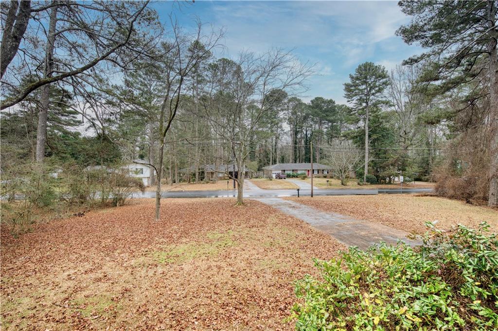 6100 Mincey Road Stone Mountain, GA 30087 - Photo 29 of 40 a street view with large trees