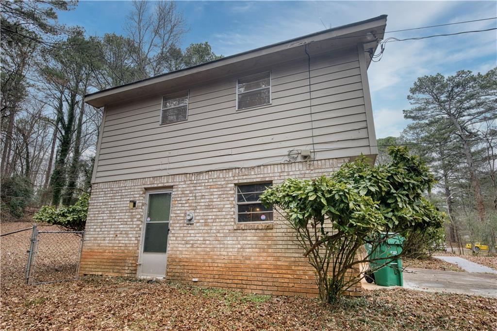6100 Mincey Road Stone Mountain, GA 30087 - Photo 33 of 40 a view of a house with a yard