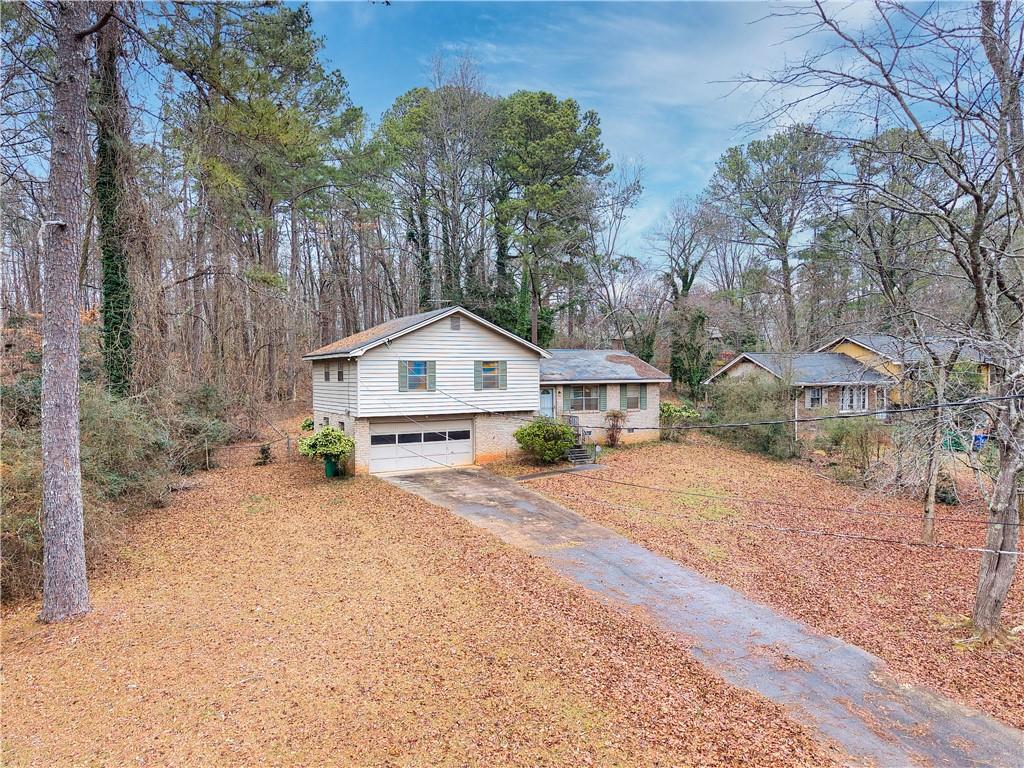 6100 Mincey Road Stone Mountain, GA 30087 - Photo 40 of 40 a front view of a house with a yard and garage