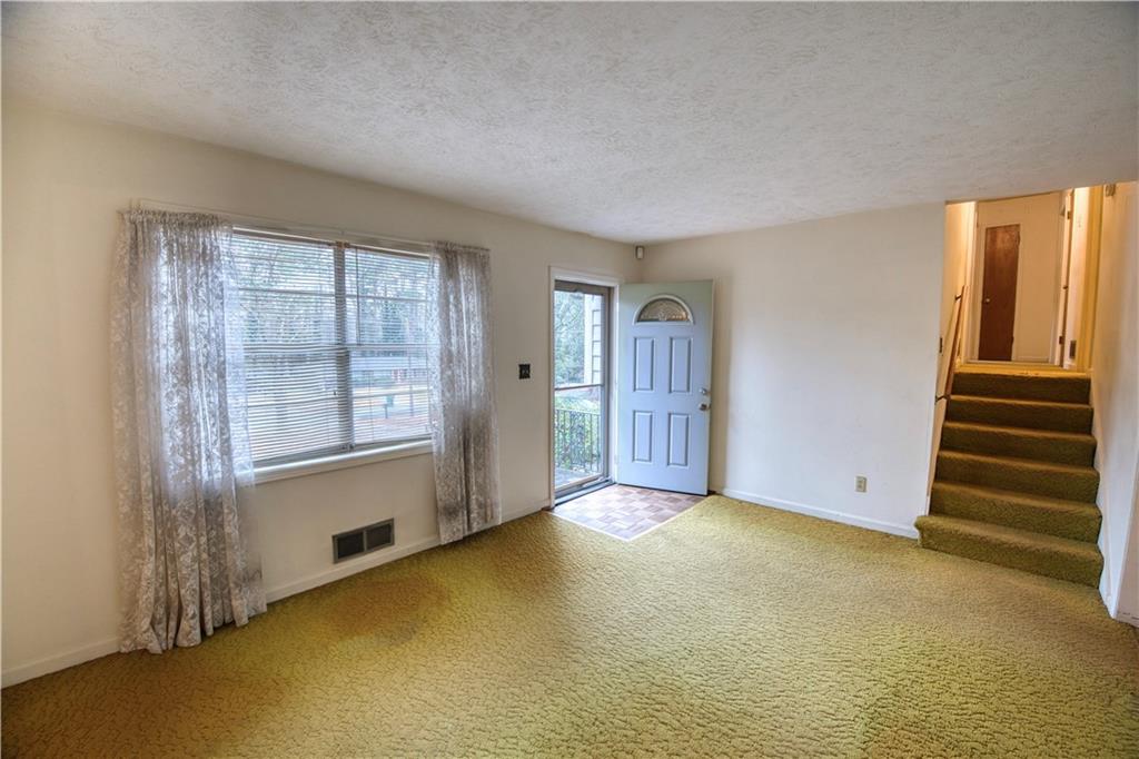 6100 Mincey Road Stone Mountain, GA 30087 - Photo 4 of 40 an empty room with windows