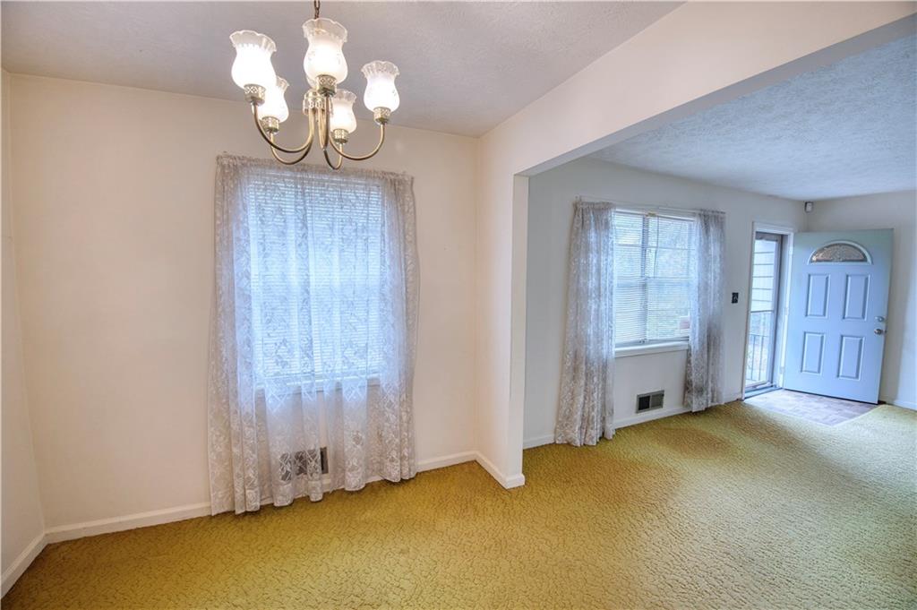 6100 Mincey Road Stone Mountain, GA 30087 - Photo 6 of 40 a view of an empty room with a chandelier