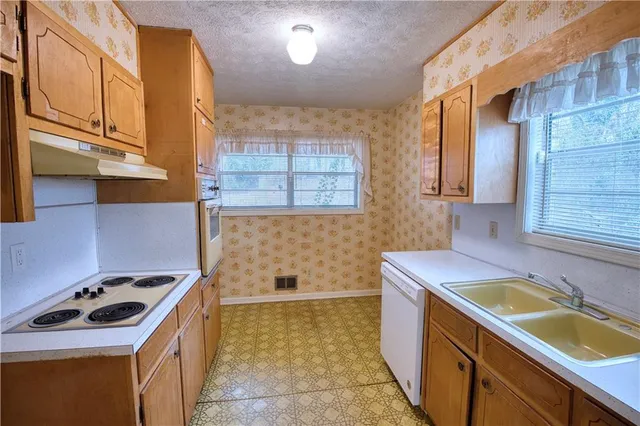 a kitchen that has a sink and a stove