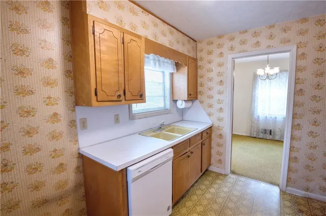 wooden floor in an empty room with a bathroom
