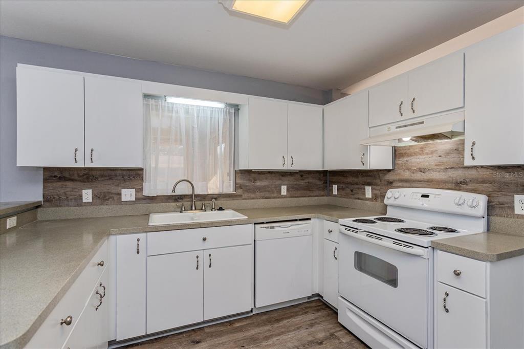 6114 Southwest 104th Street Ocala, FL 34476 - Photo 11 of 28 a kitchen with cabinets appliances a sink and a window
