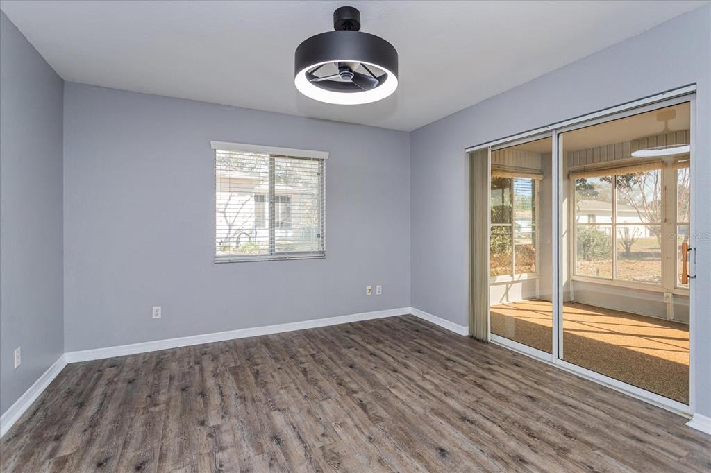 6114 Southwest 104th Street Ocala, FL 34476 - Photo 13 of 28 a view of an empty room with wooden floor and a window
