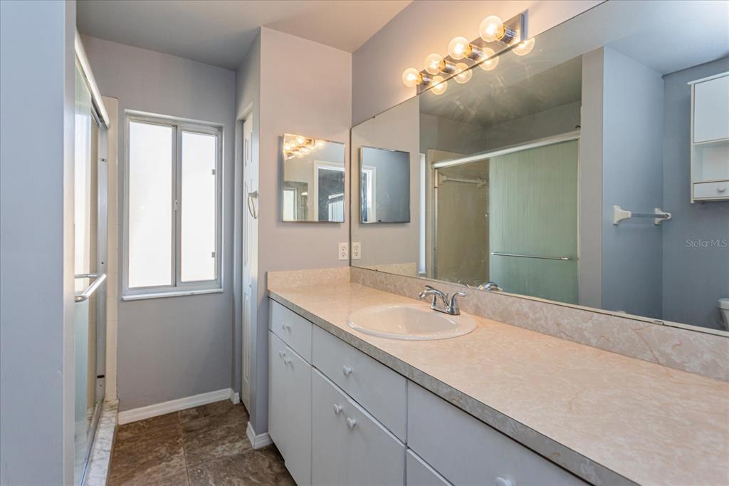 6114 Southwest 104th Street Ocala, FL 34476 - Photo 16 of 28 a bathroom with a sink and a mirror